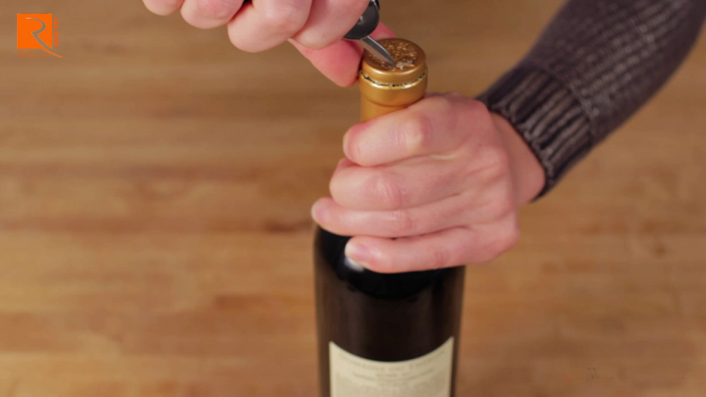 Tiếp theo, cắt một vòng tròn nhỏ hoàn toàn trên đỉnh của nút chai sao cho trùng với viền của miếng gỗ sồi.